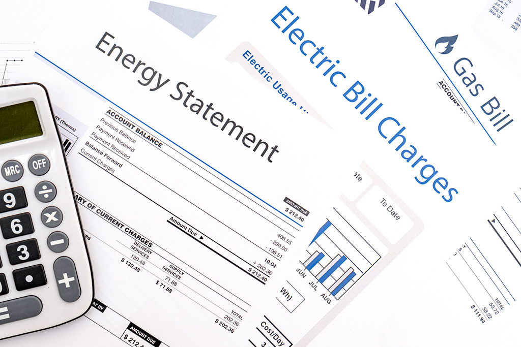Energy bill statement, electric bill statement, and gas bill statement with a calculator