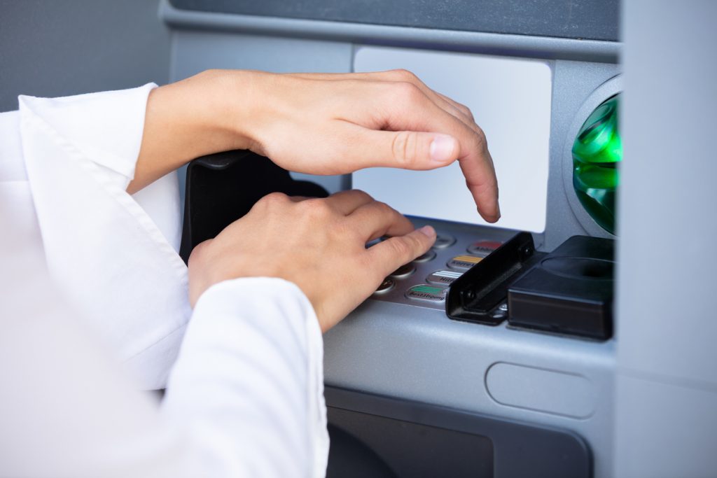 Hand covering keypad on ATM