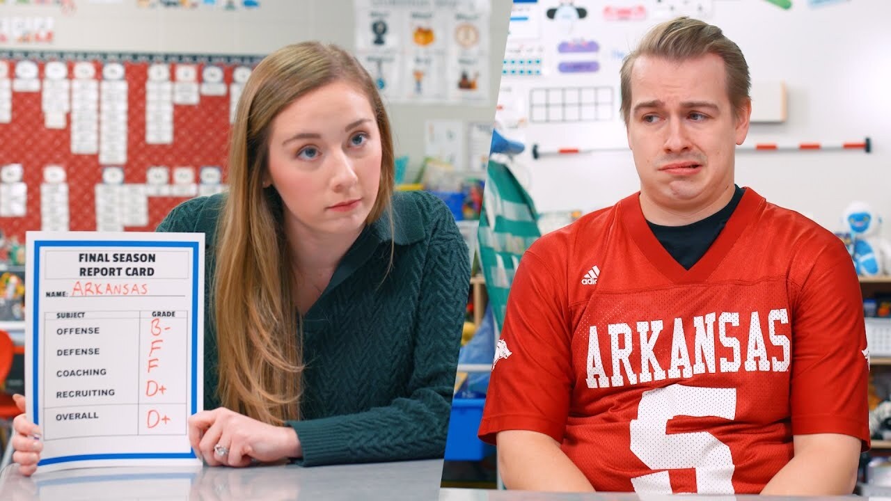 girl holding up Arkansas report card to a guy in an Arkansas jersey