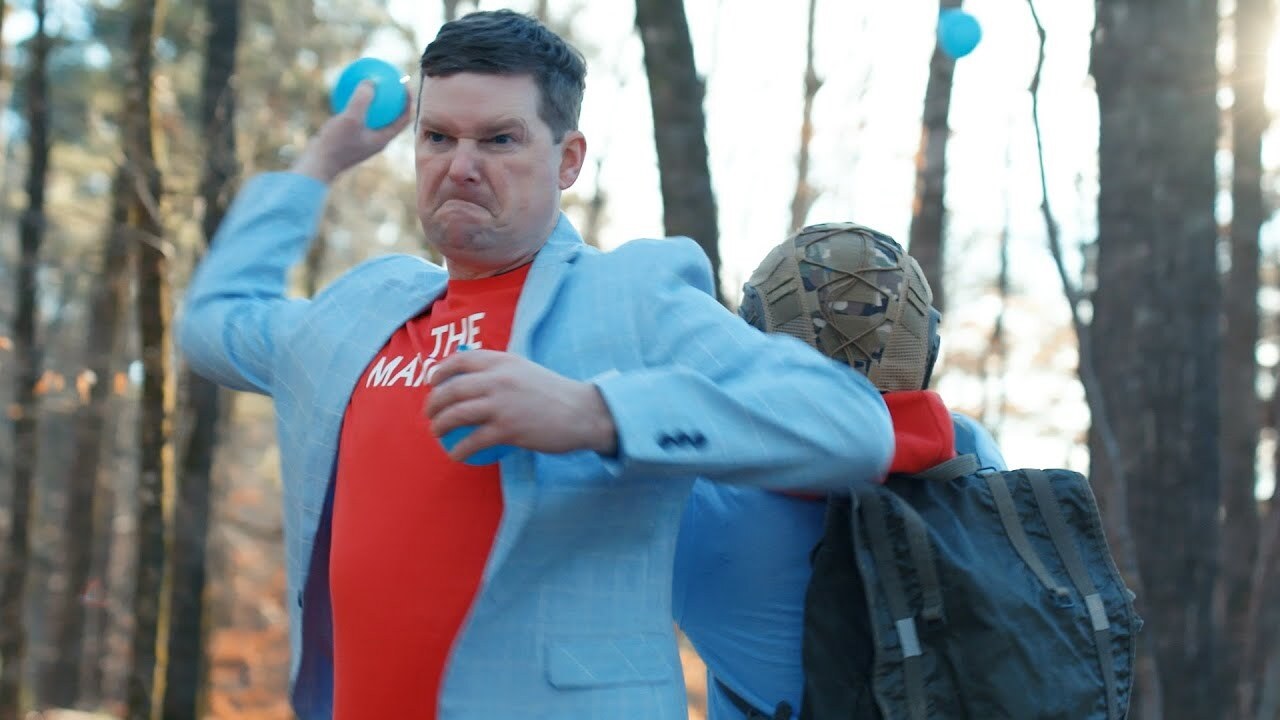 guy in powder blue jacket is throwing a ball