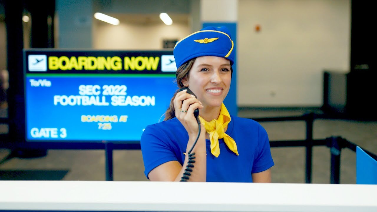 Flight attendant announcing SEC teams for boarding