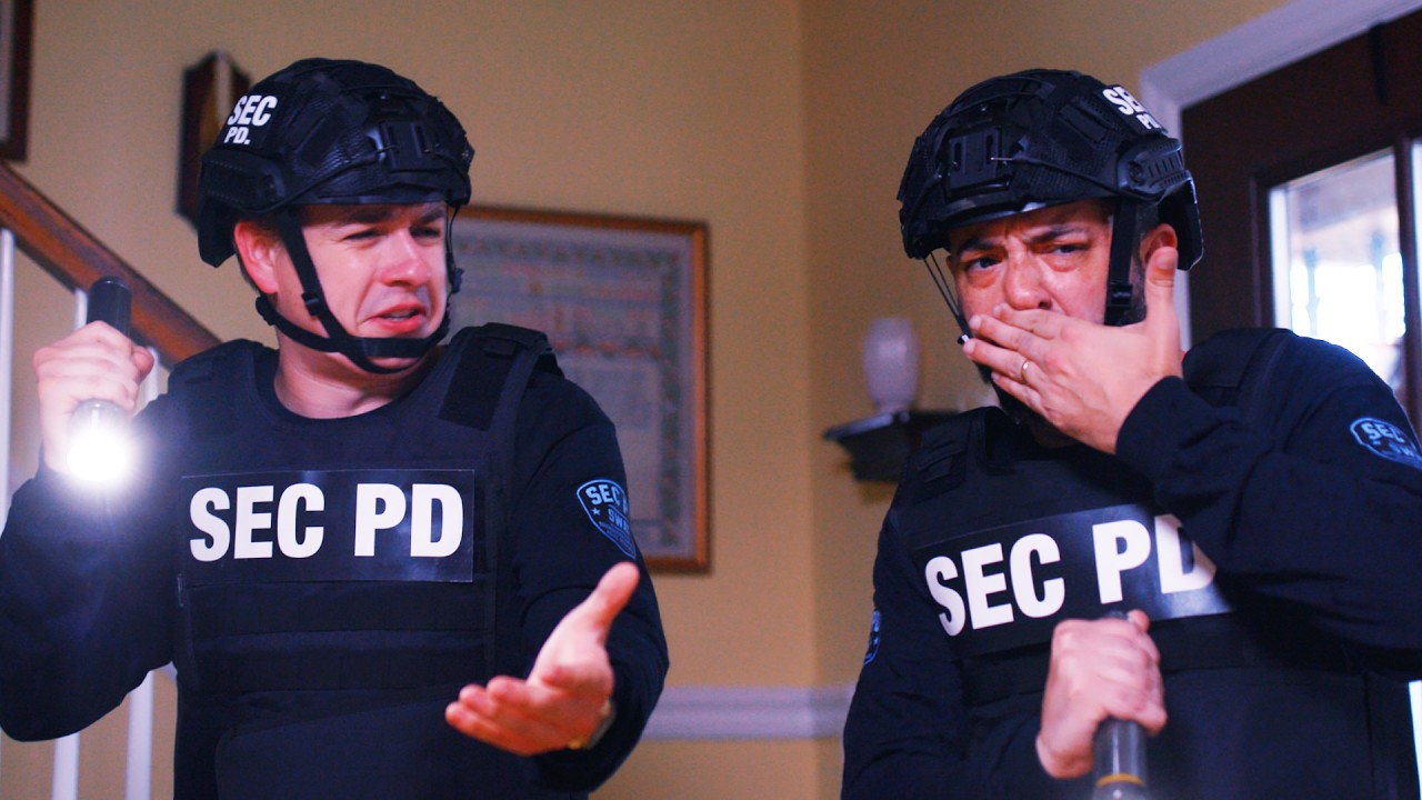two men in police uniforms that read "SEC PD" across the chest