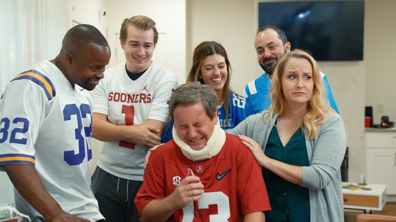 Players in jerseys crowded around a hurt player