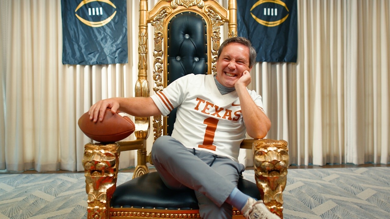 photo of a person in a texas jersey holding a football and sitting on a throne